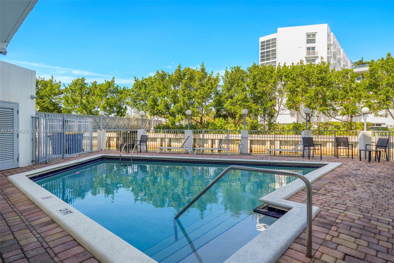 1674 Bay Road, Unit 401 Miami Beach, FL 33139 - Photo 28 of 33 a view of a swimming pool with a patio