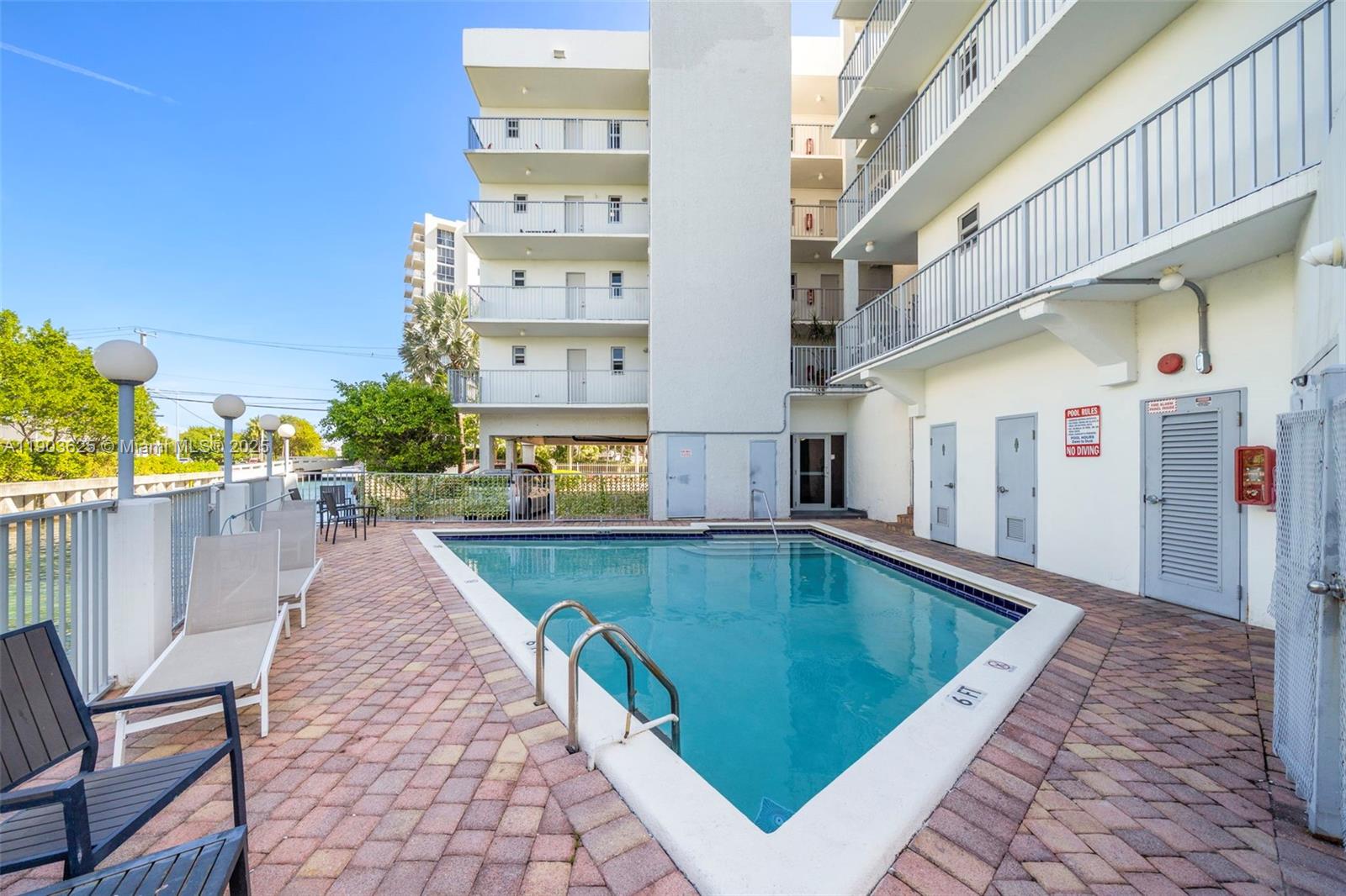 1674 Bay Road, Unit 401 Miami Beach, FL 33139 - Photo 29 of 33 a swimming pool with outdoor seating and yard