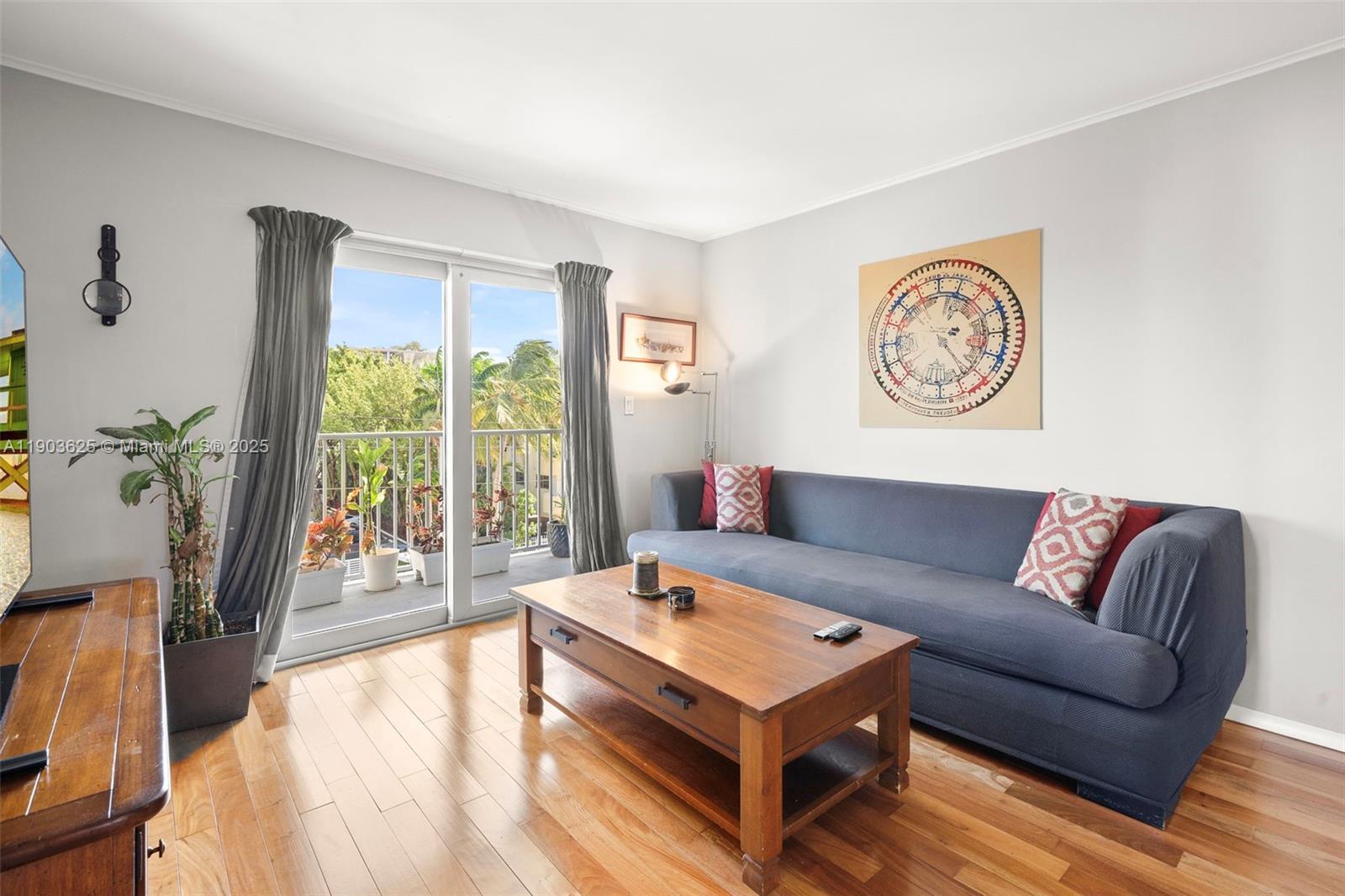 1674 Bay Road, Unit 401 Miami Beach, FL 33139 - Photo 3 of 33 a living room with furniture and a large window