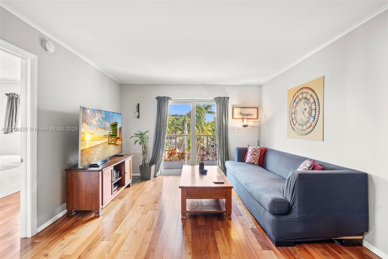 1674 Bay Road, Unit 401 Miami Beach, FL 33139 - Photo 4 of 33 a living room with furniture and a flat screen tv