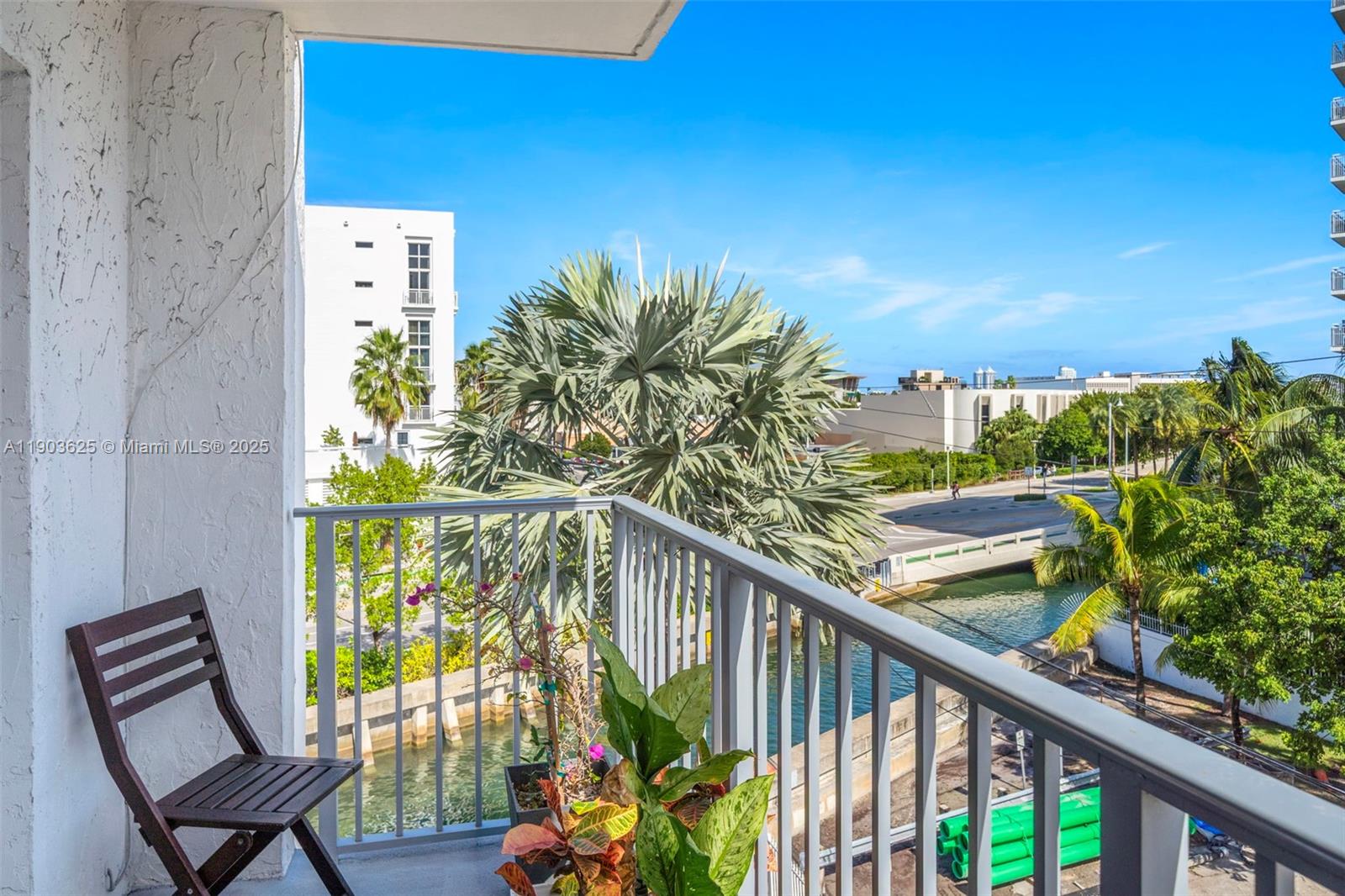 1674 Bay Road, Unit 401 Miami Beach, FL 33139 - Photo 5 of 33 a view of a balcony with wooden floor and outdoor seating