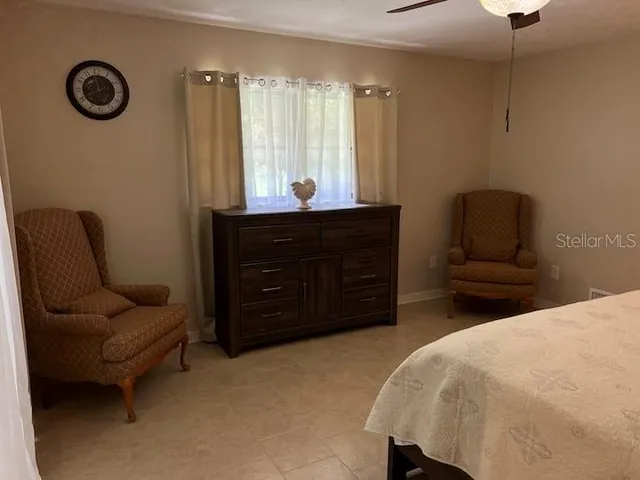 a bedroom with a bed and a couch