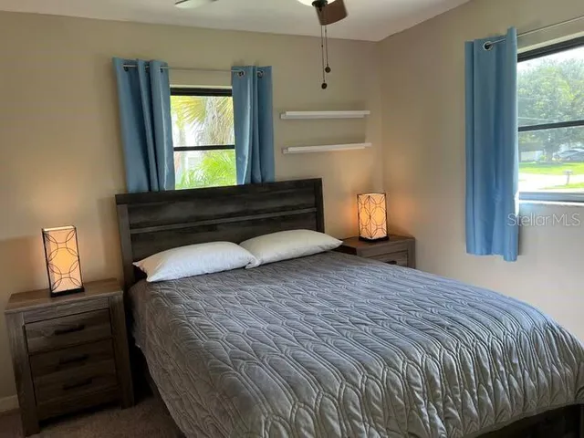 a bedroom with a bed and a window
