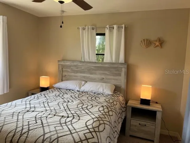 a bedroom with a bed and a lamp