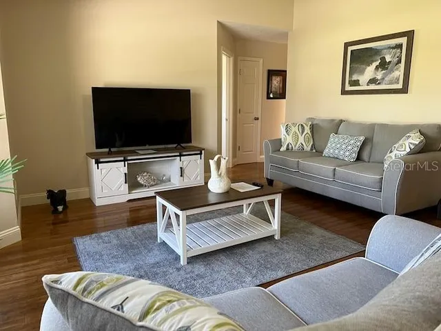 a living room with furniture and a flat screen tv