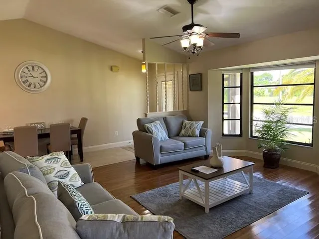 a living room with furniture and a large window