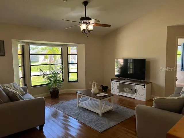 a living room with furniture and a flat screen tv