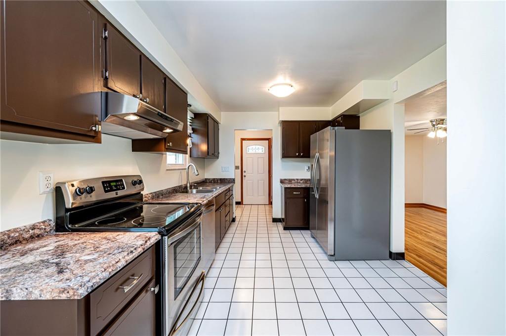 128 Reservoir Hill Road Uniontown, PA 15401 - Photo 11 of 30 a kitchen with a stove a refrigerator and a cabinets