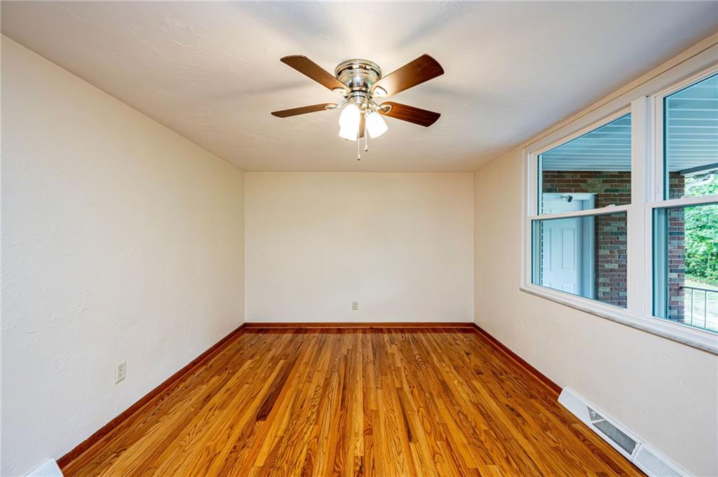 128 Reservoir Hill Road Uniontown, PA 15401 - Photo 16 of 30 a view of a room with wooden floor and ceiling fan