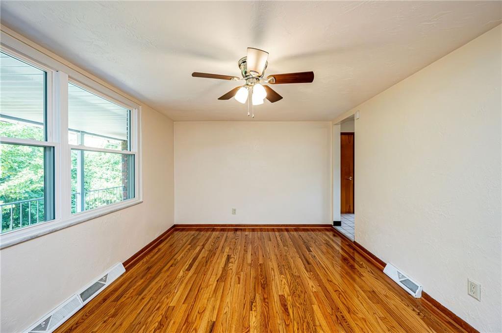128 Reservoir Hill Road Uniontown, PA 15401 - Photo 17 of 30 a view of empty room with wooden floor and fan