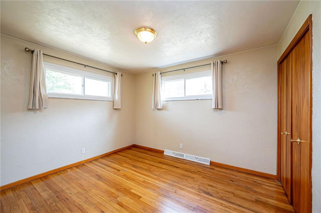 128 Reservoir Hill Road Uniontown, PA 15401 - Photo 22 of 30 an empty room with wooden floor and windows