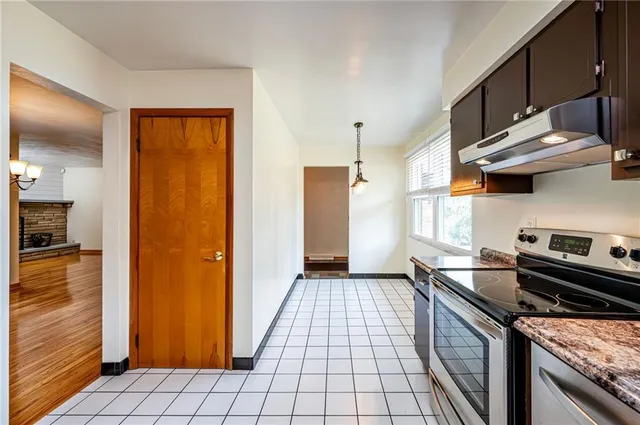 a kitchen with stainless steel appliances granite countertop a stove and a refrigerator