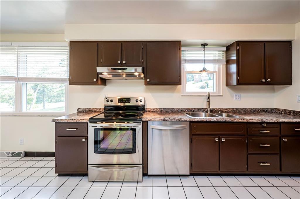 128 Reservoir Hill Road Uniontown, PA 15401 - Photo 9 of 30 a kitchen with stainless steel appliances granite countertop a stove a sink and a microwave