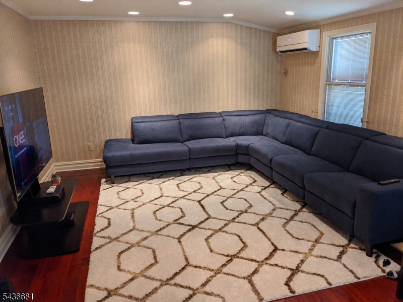 178 East Lindsley Road, Unit 2 Cedar Grove, NJ 07009 - Photo 9 of 28 a living room with a couch and a flat screen tv