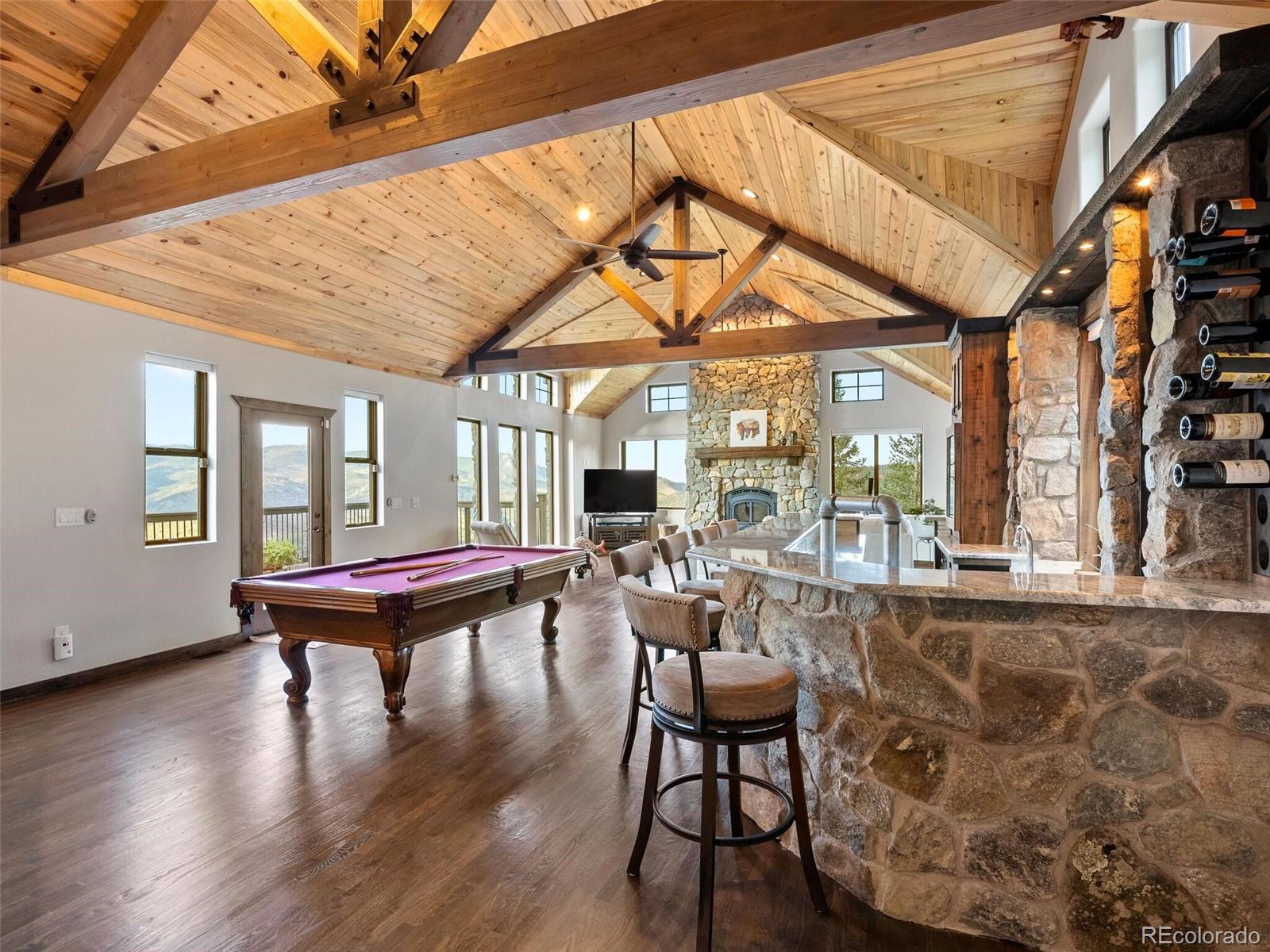913 Saddle Ridge Drive Evergreen, CO 80439 - Photo 13 of 50 a living room with fireplace furniture and a large window
