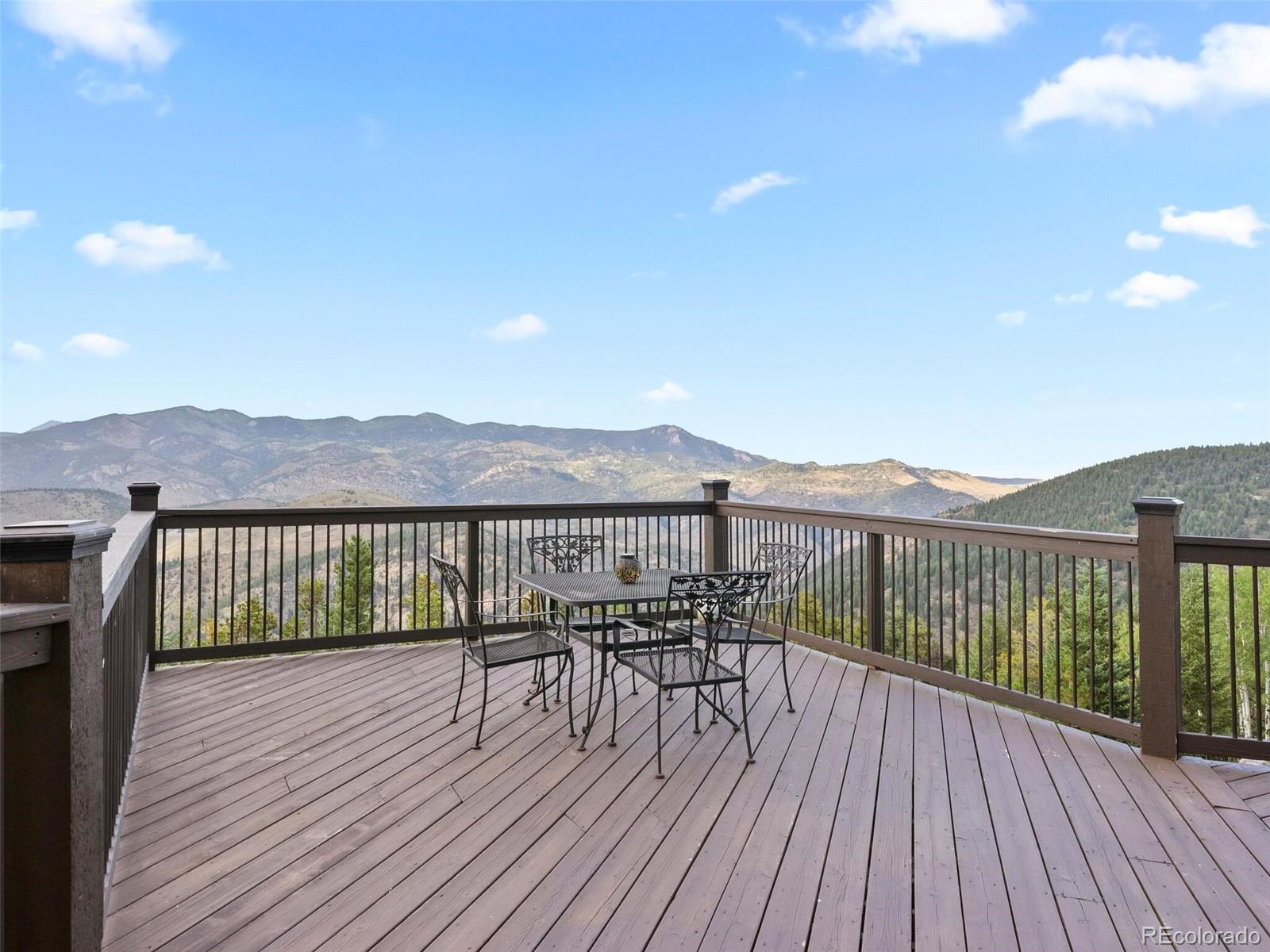 913 Saddle Ridge Drive Evergreen, CO 80439 - Photo 23 of 50 a view of a balcony with wooden floor and fence