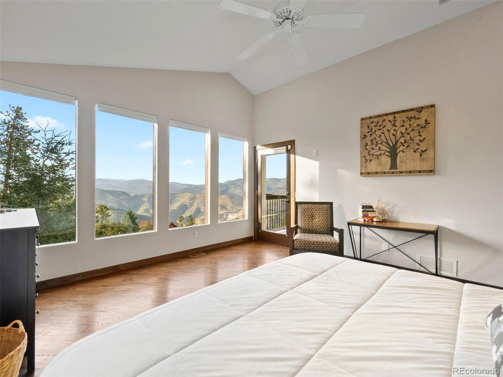 913 Saddle Ridge Drive Evergreen, CO 80439 - Photo 28 of 50 a bedroom with furniture and large windows