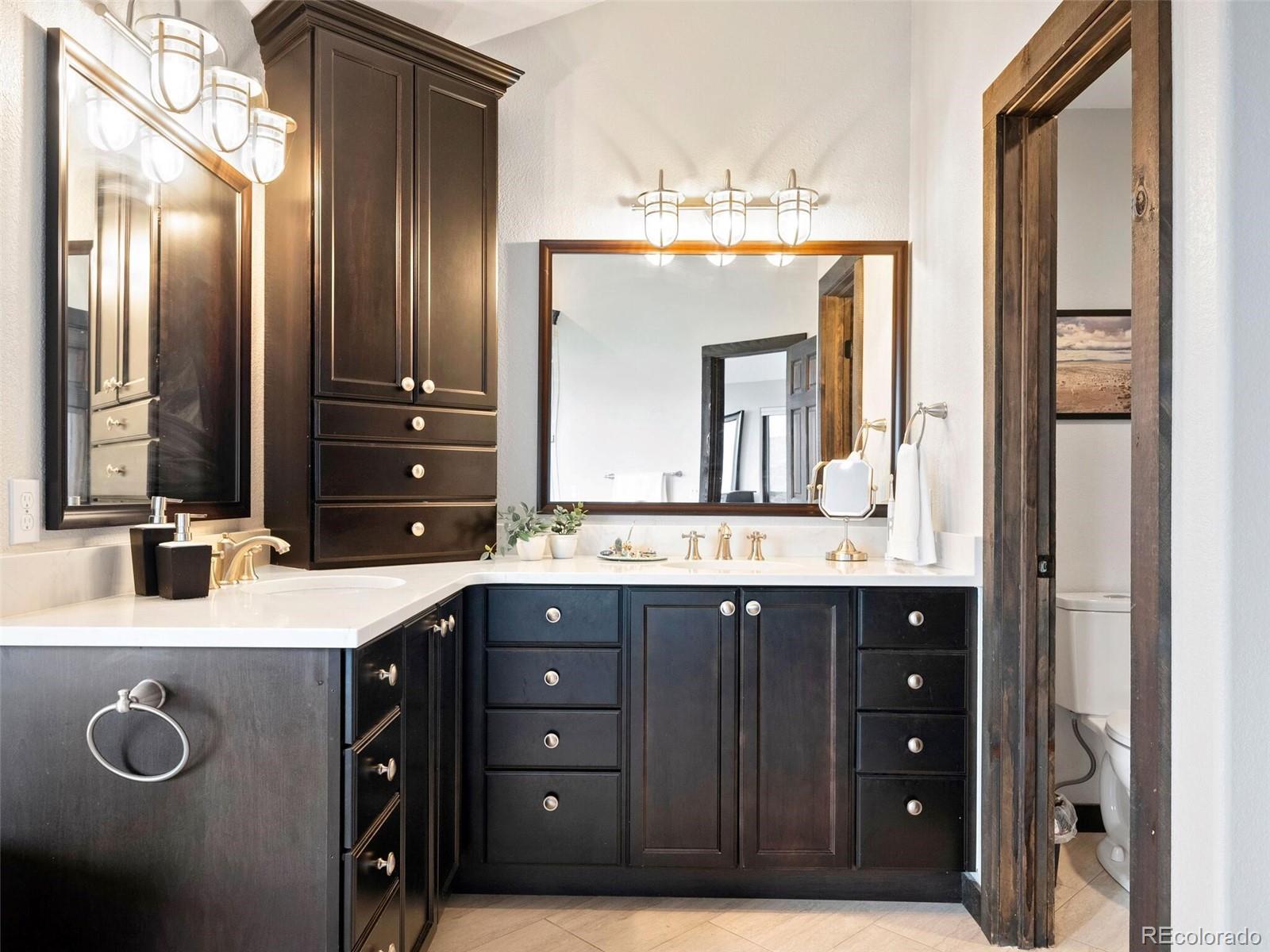 913 Saddle Ridge Drive Evergreen, CO 80439 - Photo 30 of 50 a bathroom with a sink double vanity and a mirror