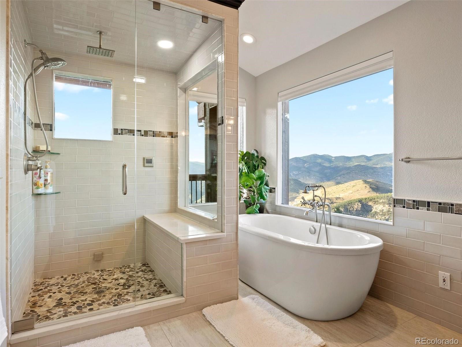 913 Saddle Ridge Drive Evergreen, CO 80439 - Photo 31 of 50 a bathroom with a bathtub and sink