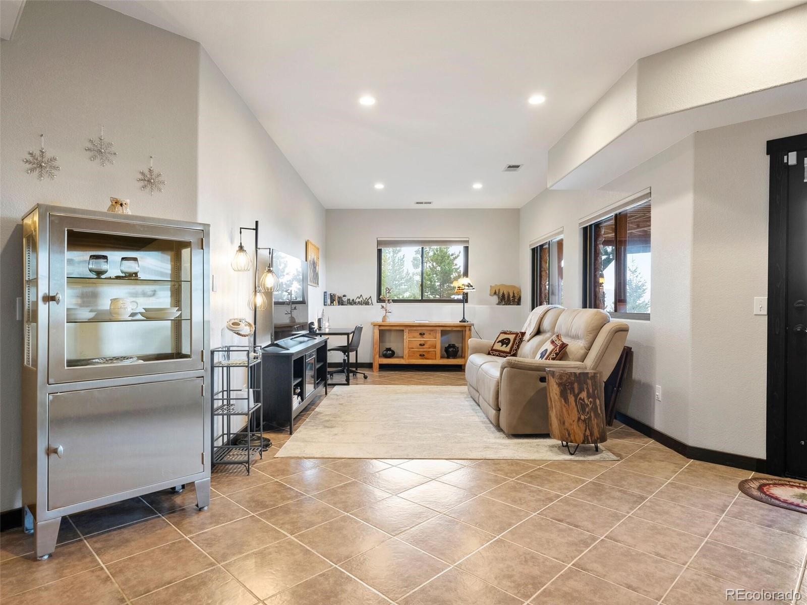 913 Saddle Ridge Drive Evergreen, CO 80439 - Photo 36 of 50 a living room with furniture and large window