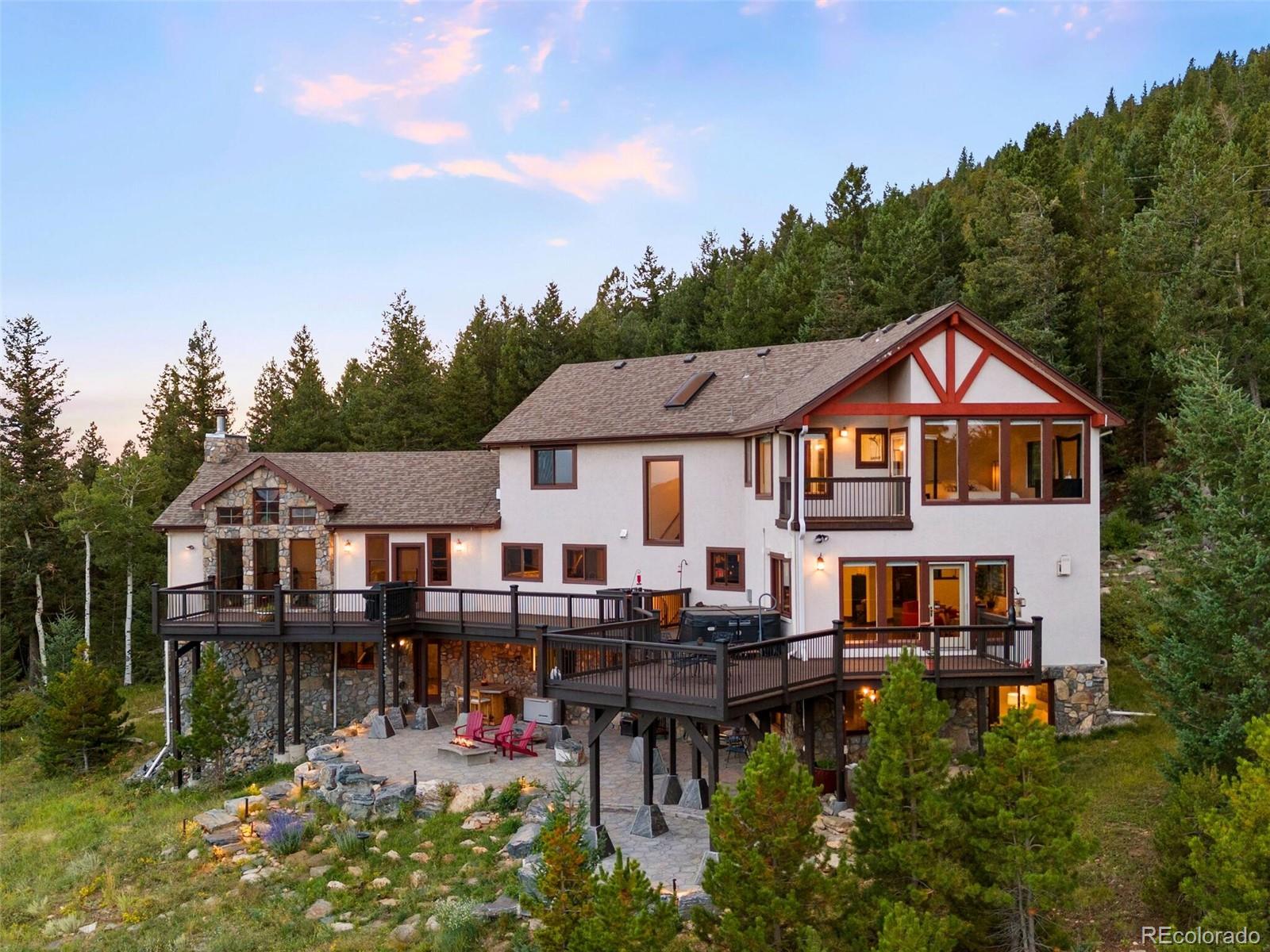 913 Saddle Ridge Drive Evergreen, CO 80439 - Photo 42 of 50 a front view of a house with swimming pool and sitting area