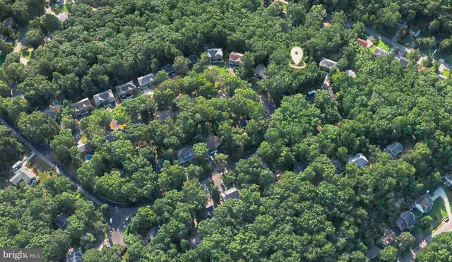 an aerial view of a house with yard