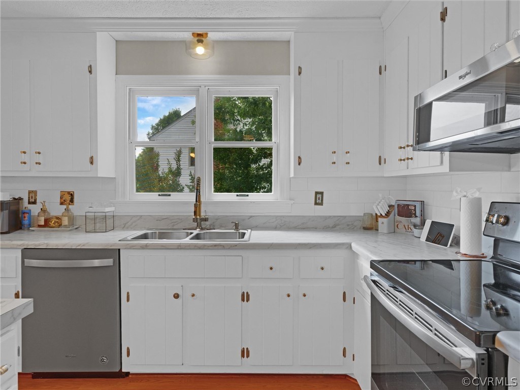 10912 Rufford Road Chester, VA 23831 - Photo 12 of 48 a kitchen with stainless steel appliances white cabinets and a sink