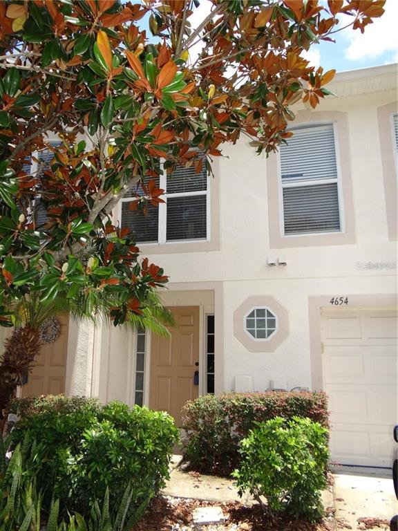 4654 Ashburn Square Drive Tampa, FL 33610 - Photo 1 of 11 a front view of a house with a tree