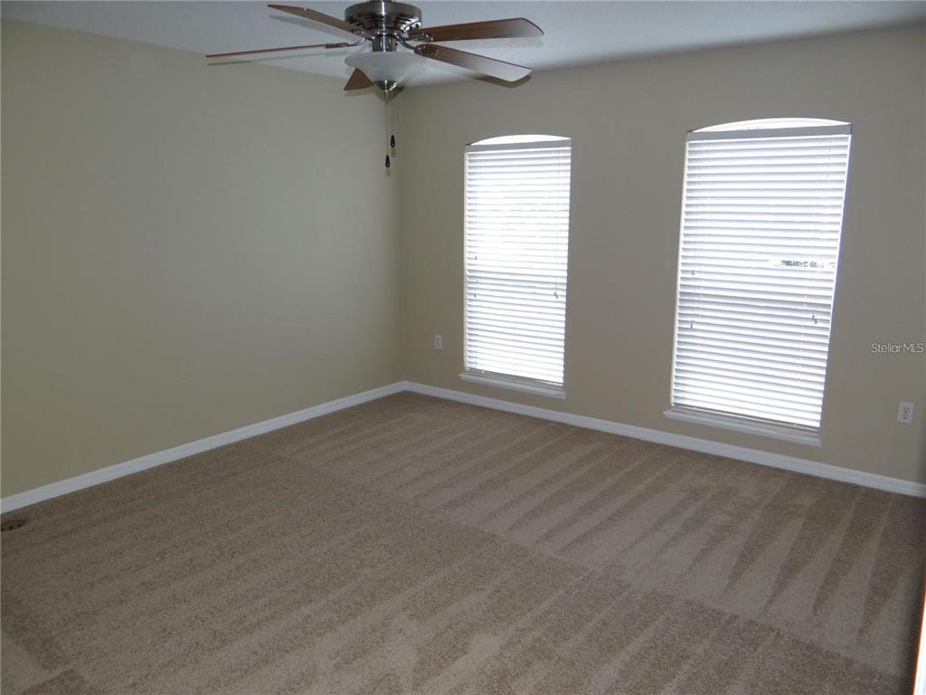 4654 Ashburn Square Drive Tampa, FL 33610 - Photo 9 of 11 an empty room with a window and a fan