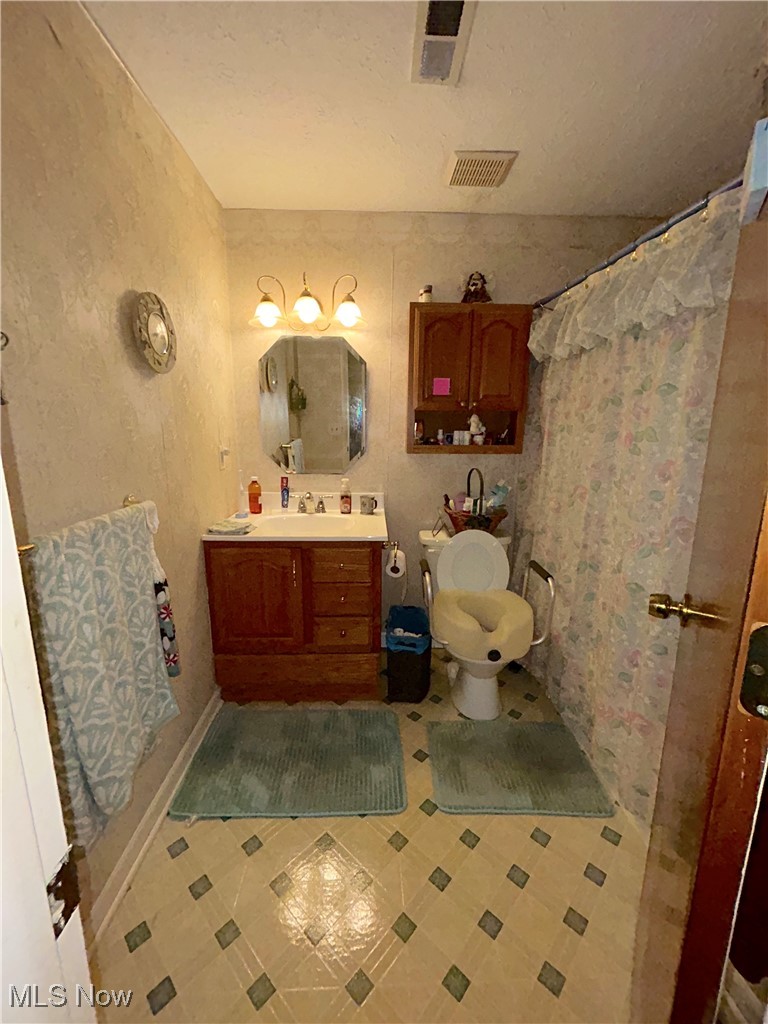 8753 West Ridge Road, Unit A Elyria, OH 44035 - Photo 5 of 21 Full bath featuring vanity, tile patterned vinyl flooring, and curtained shower