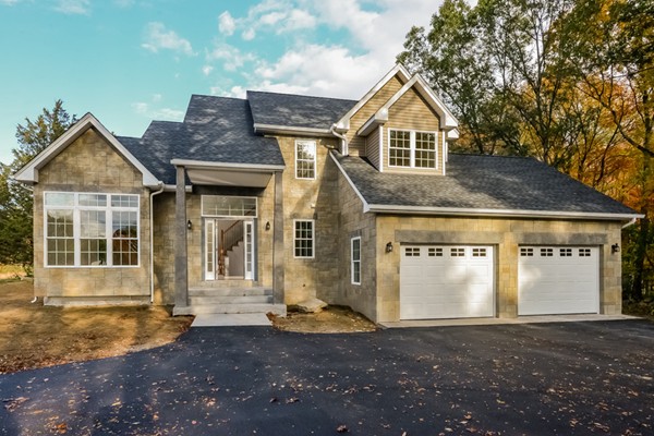 a front view of a house with a yard garage and window