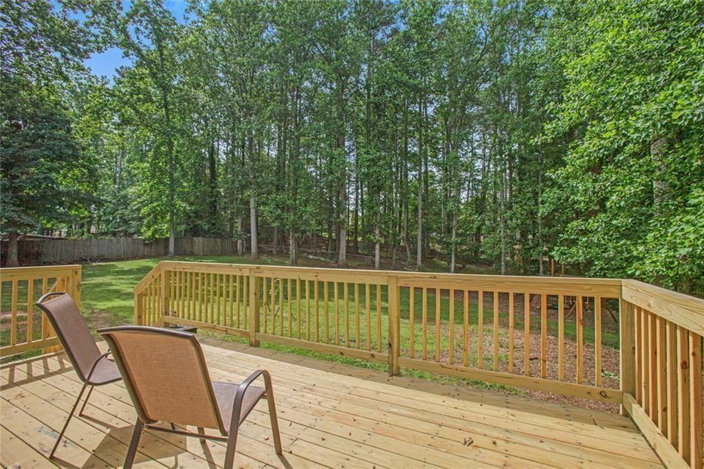 2482 Windchase Court Buford, GA 30518 - Photo 17 of 36 a view of a chair and table on the wooden deck
