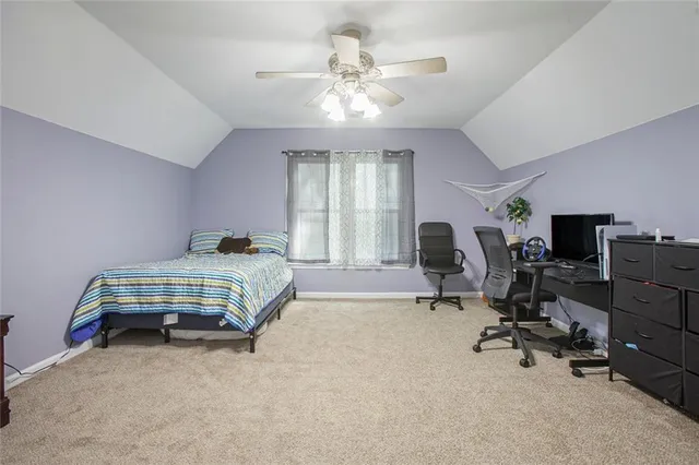 a bedroom with bed and a chandelier