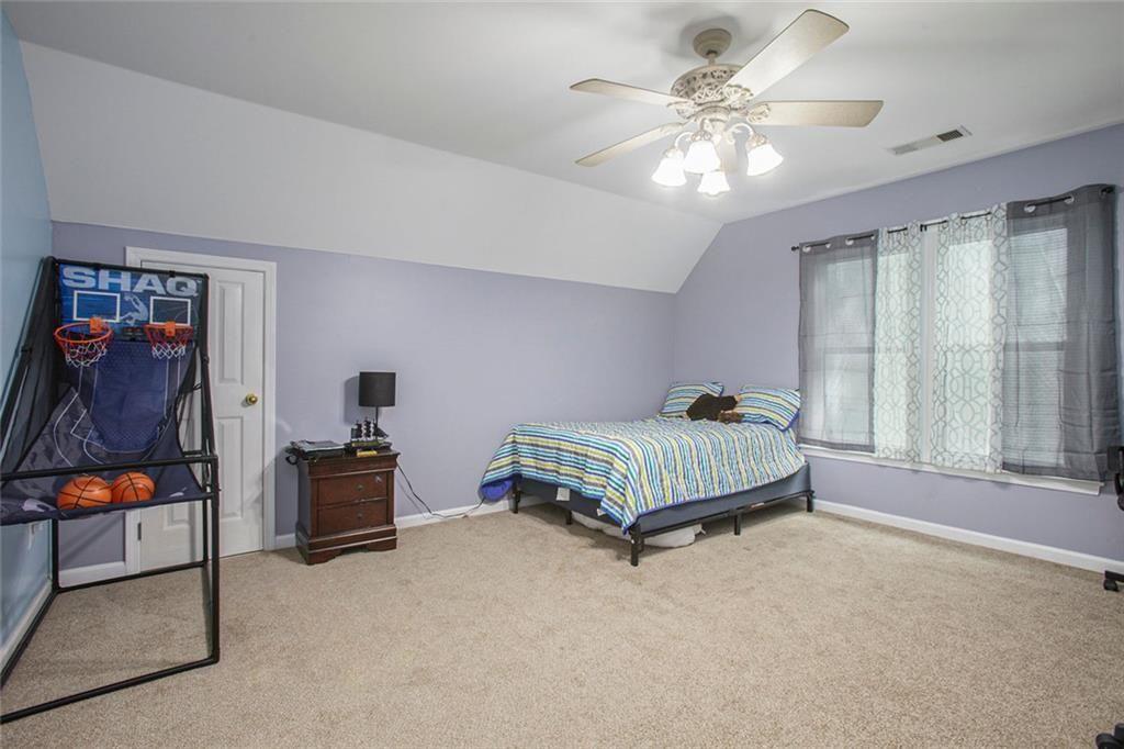 2482 Windchase Court Buford, GA 30518 - Photo 18 of 33 a bedroom with a bed and window