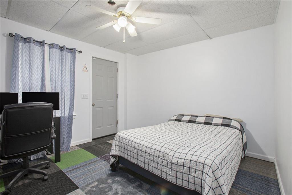 2482 Windchase Court Buford, GA 30518 - Photo 19 of 33 a bedroom with a bed and a chandelier