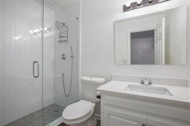 a bathroom with a toilet a sink and shower