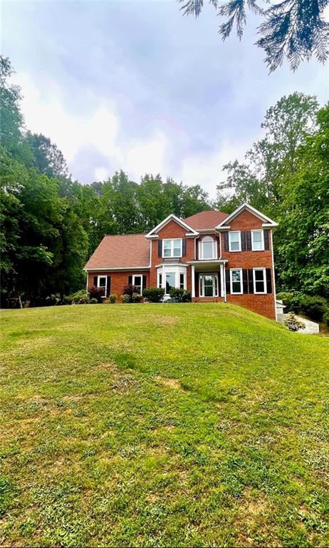 2482 Windchase Court Buford, GA 30518 - Photo 2 of 36 a front view of a house with garden