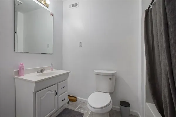 a backyard of a house with childrens swings and slides