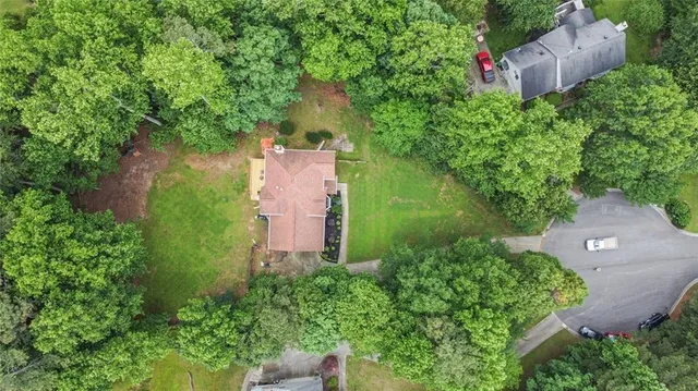 an aerial view of a house with a yard and a water fountain