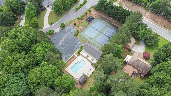 an aerial view of a house with a yard and outdoor seating