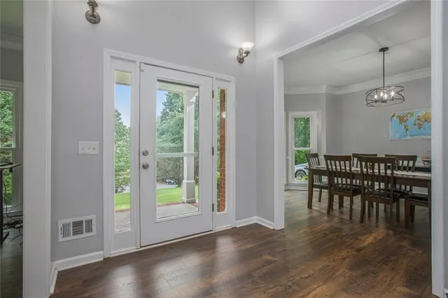 a view of a dining room with furniture window and wooden floor