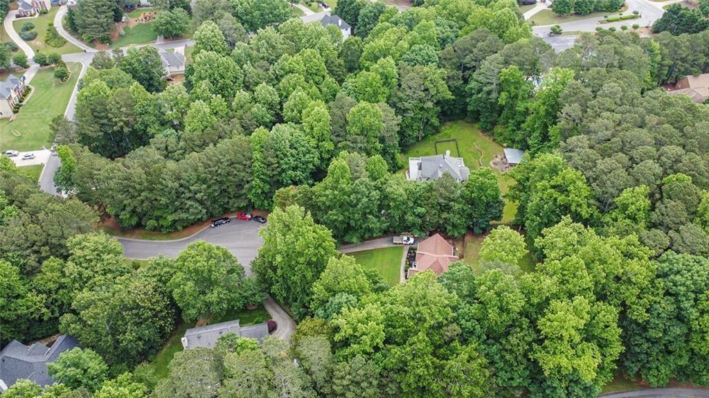 2482 Windchase Court Buford, GA 30518 - Photo 32 of 36 an aerial view of a house with a yard and large trees