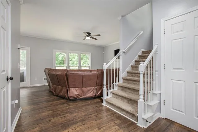 a living room with wooden floor furniture and a window