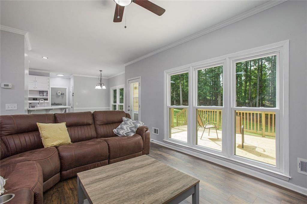 2482 Windchase Court Buford, GA 30518 - Photo 6 of 36 a living room with furniture and a large window