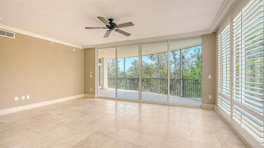 401 North Point Road, Unit 301 Osprey, FL 34229 - Photo 12 of 91 a view of an empty room and window ceiling fan