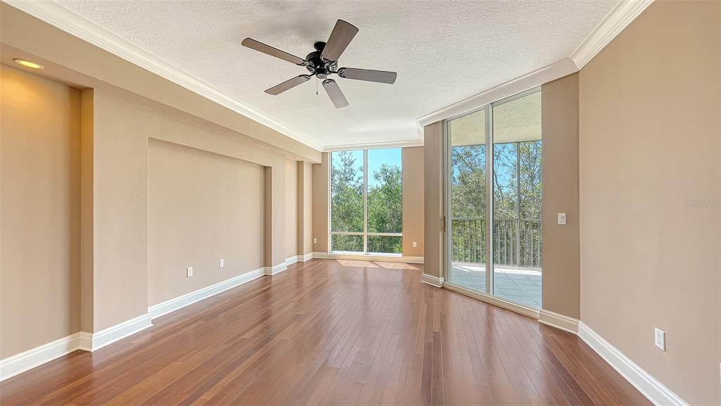 401 North Point Road, Unit 301 Osprey, FL 34229 - Photo 23 of 91 a view of a livingroom with a ceiling fan and window