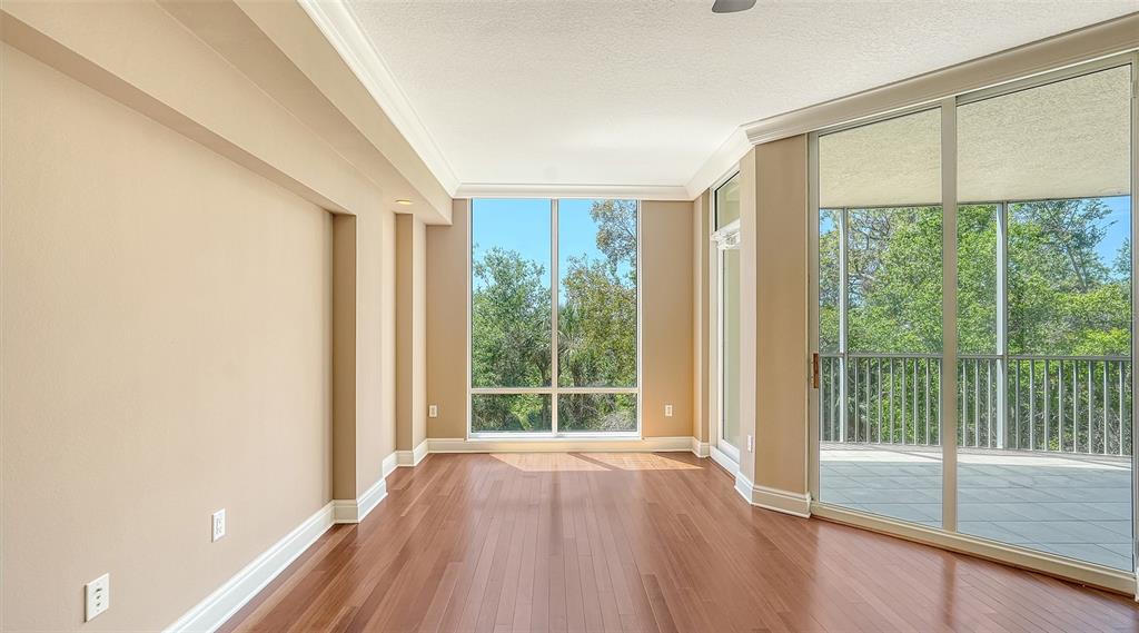 401 North Point Road, Unit 301 Osprey, FL 34229 - Photo 24 of 91 a view of room with window and wooden floor