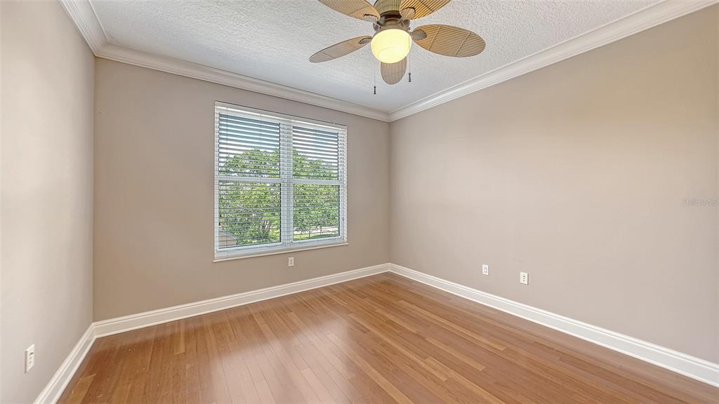 401 North Point Road, Unit 301 Osprey, FL 34229 - Photo 31 of 91 an empty room with a chandelier fan and windows