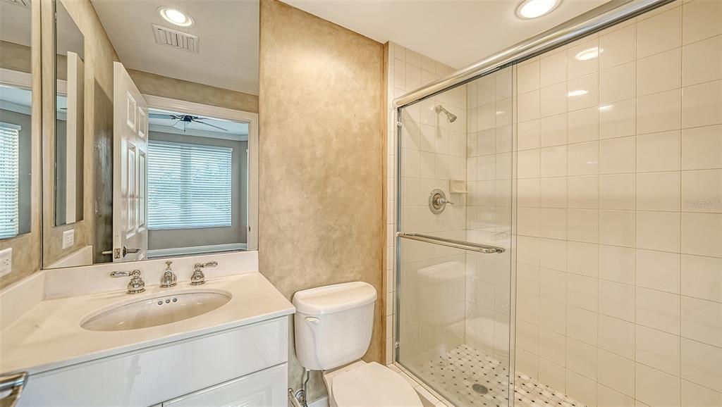 401 North Point Road, Unit 301 Osprey, FL 34229 - Photo 34 of 91 a bathroom with a sink toilet and shower