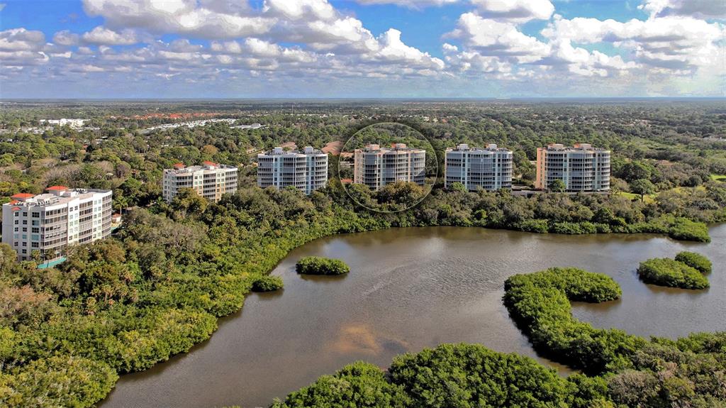 401 North Point Road, Unit 301 Osprey, FL 34229 - Photo 39 of 91 a view of a lake with building in front of it
